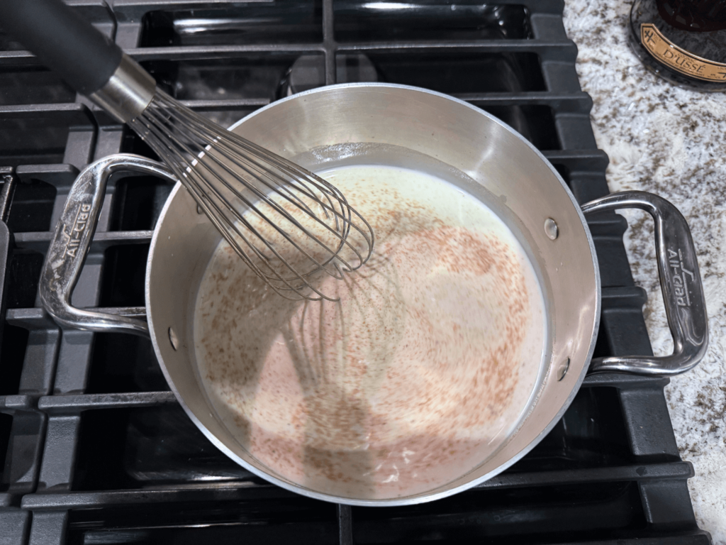 photo of milk, cream and nutmeg in a saucepan