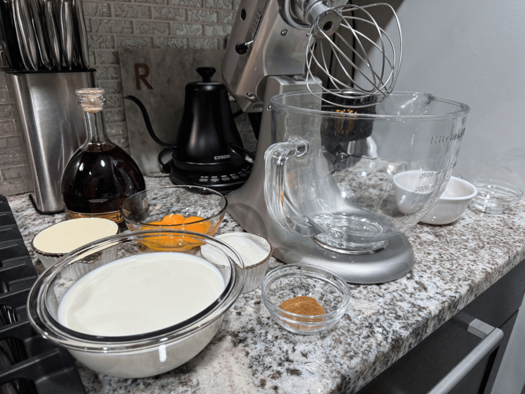 ingredients on a counter needed to make homemade spiked eggnog