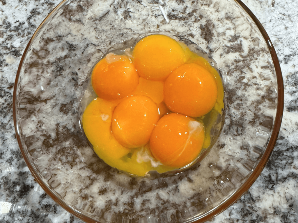 photo of 6 organic eggs in a medium mixing bowl