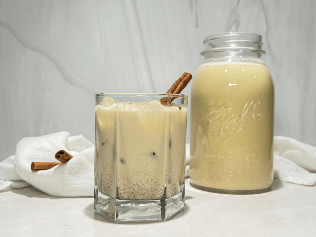 photo of homemade spiked eggnog in a glass and mason jar
