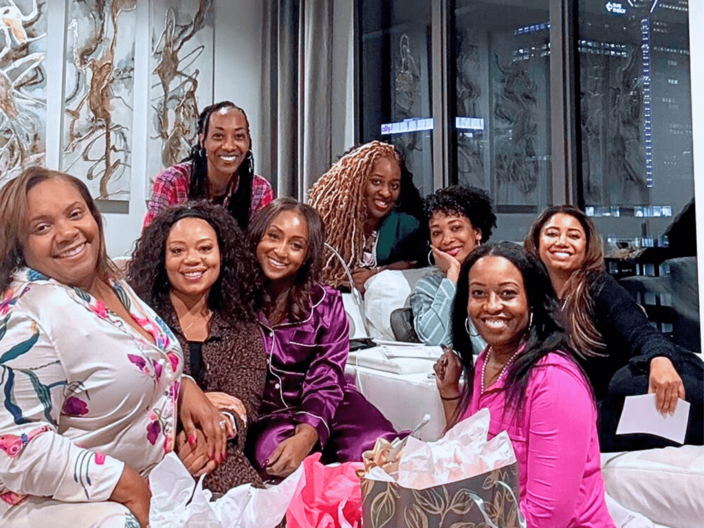 photo of a group of girls on the couch smiling at a perfume party