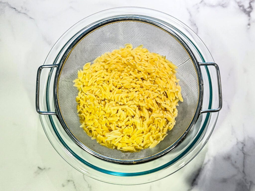 photo of orzo pasta in fine mesh strainer