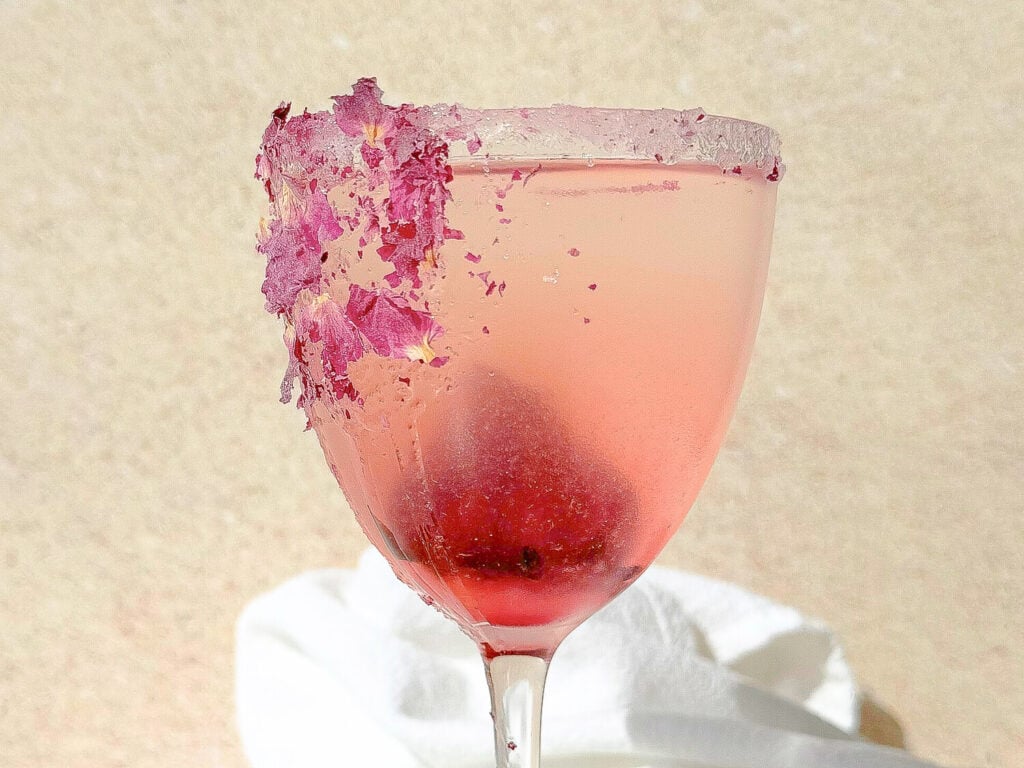 A close up photo of a rosé lemon drop martini