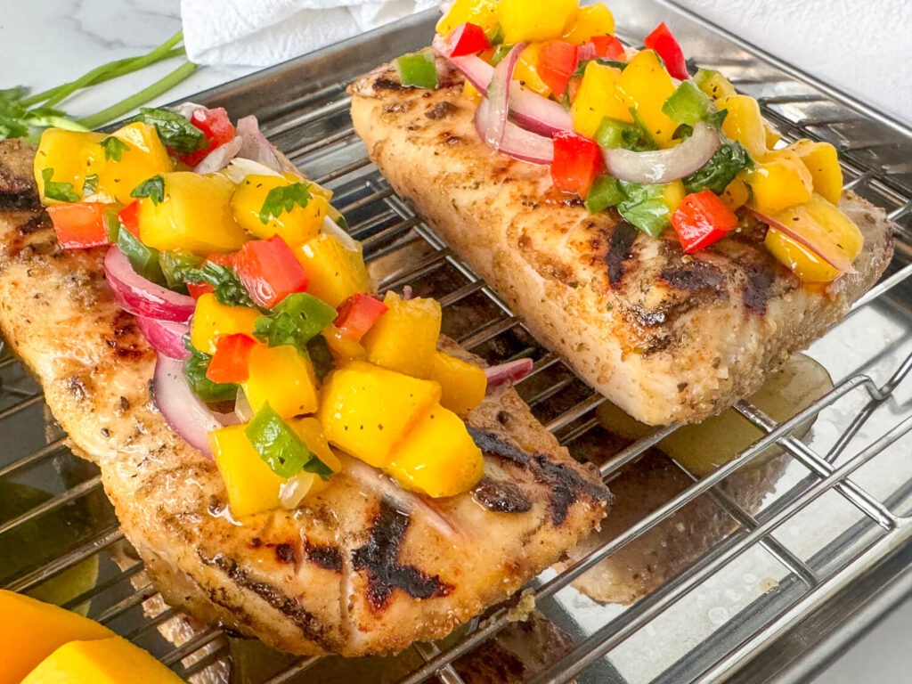 Photo of grilled fish with mango salsa on top