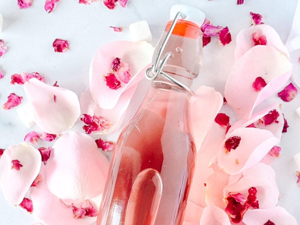 Close up photo of rose simple syrup in a airtight container