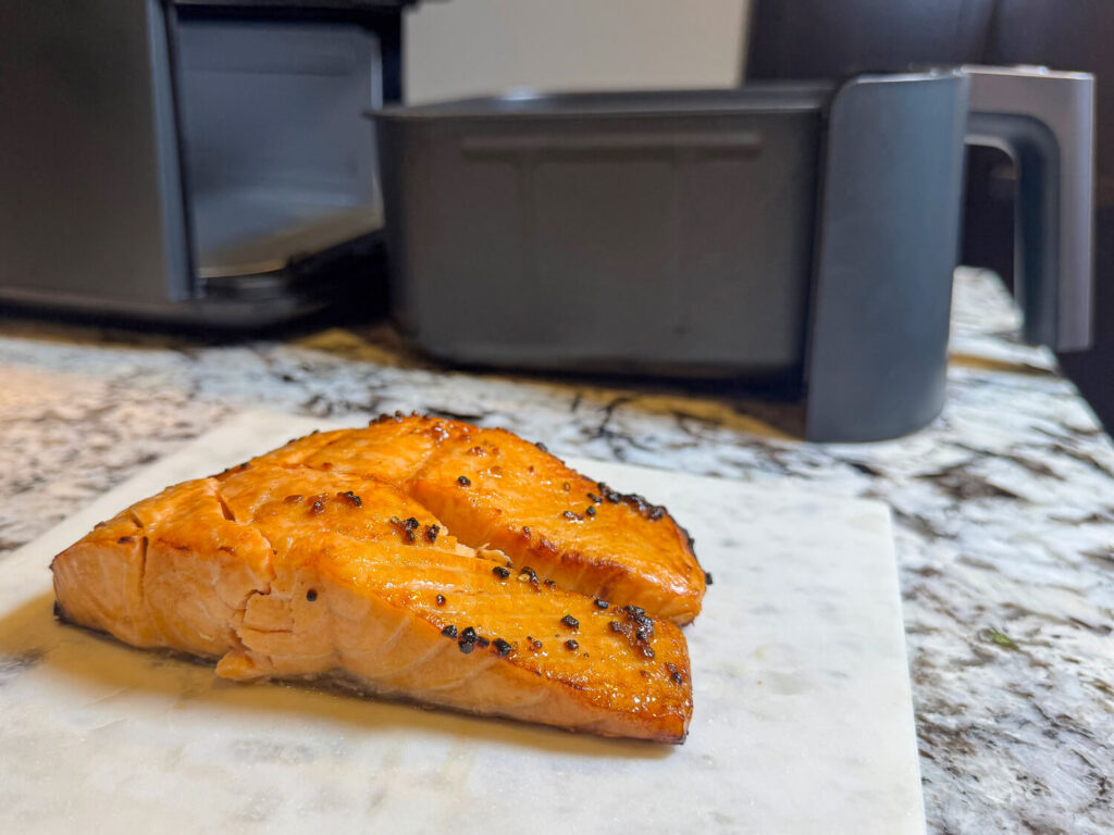 Seasoned Teriyaki Salmon in front of an air fryer