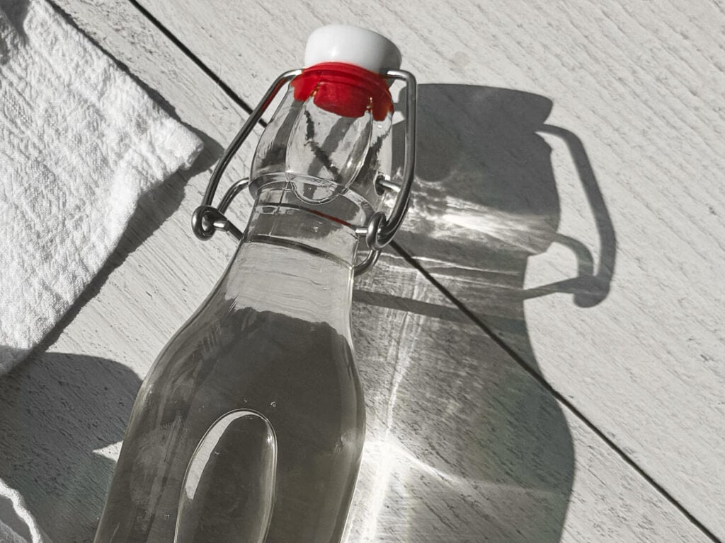 close up photo of an air tight container holding cooked simple syrup