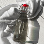 close up photo of an air tight container holding cooked simple syrup on a white towel
