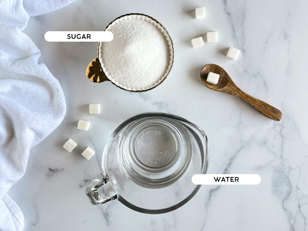flat lay of ingredients such as sugar and water on a marble surface
