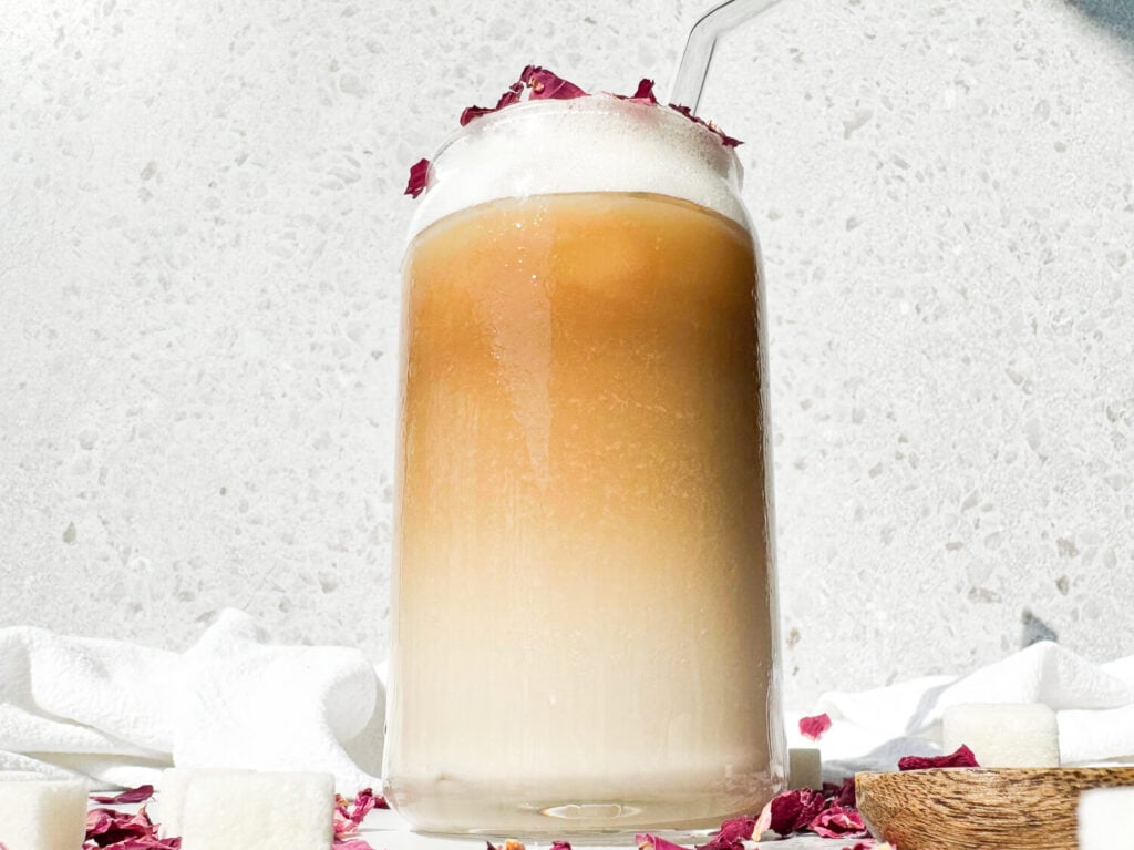 Photo of an iced rose latte in a glass cup