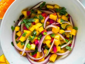 close up photo of mango salsa in a white bowl
