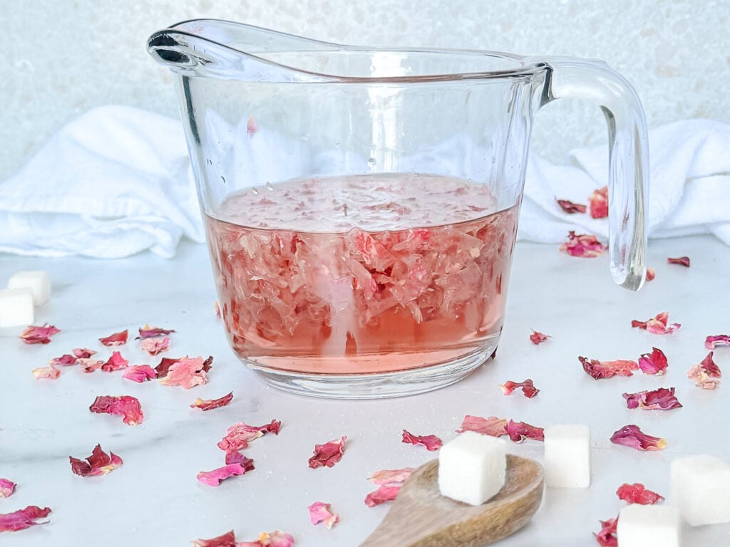 Rose simple syrup in a measurig cup.jpg