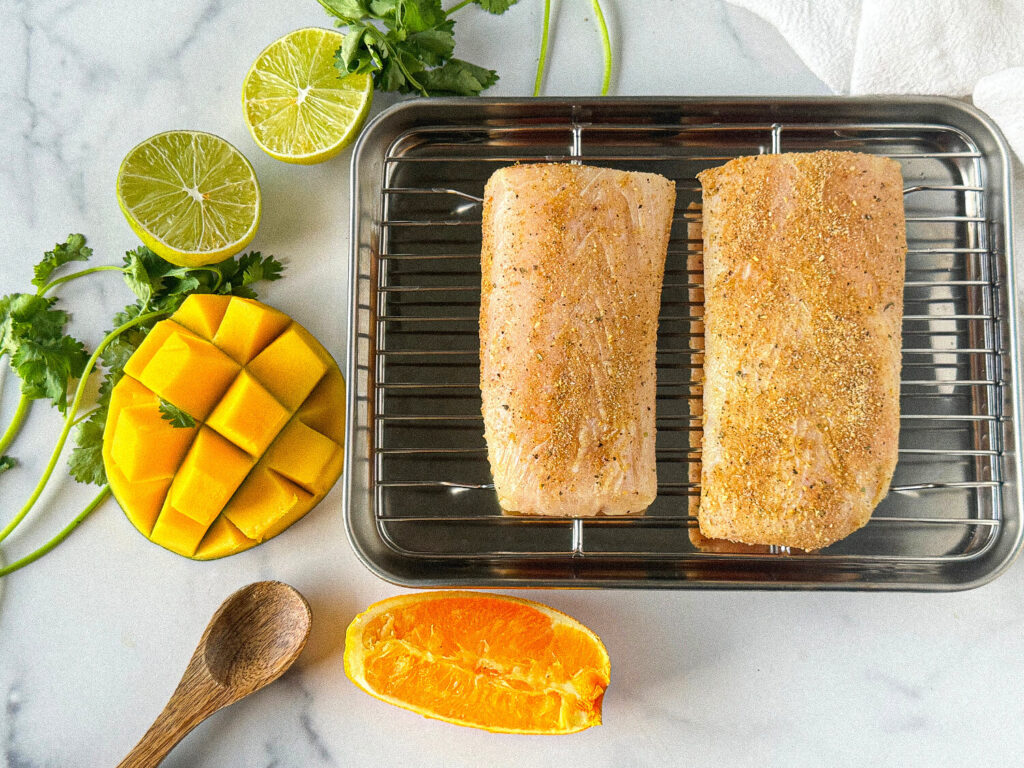 Photo of two seasoned mahi mahi fish