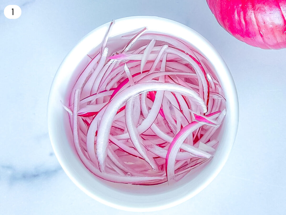 Step 1 photo of red onions soaking in water