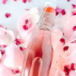 close up photo of rose simple syrup in airtight class container