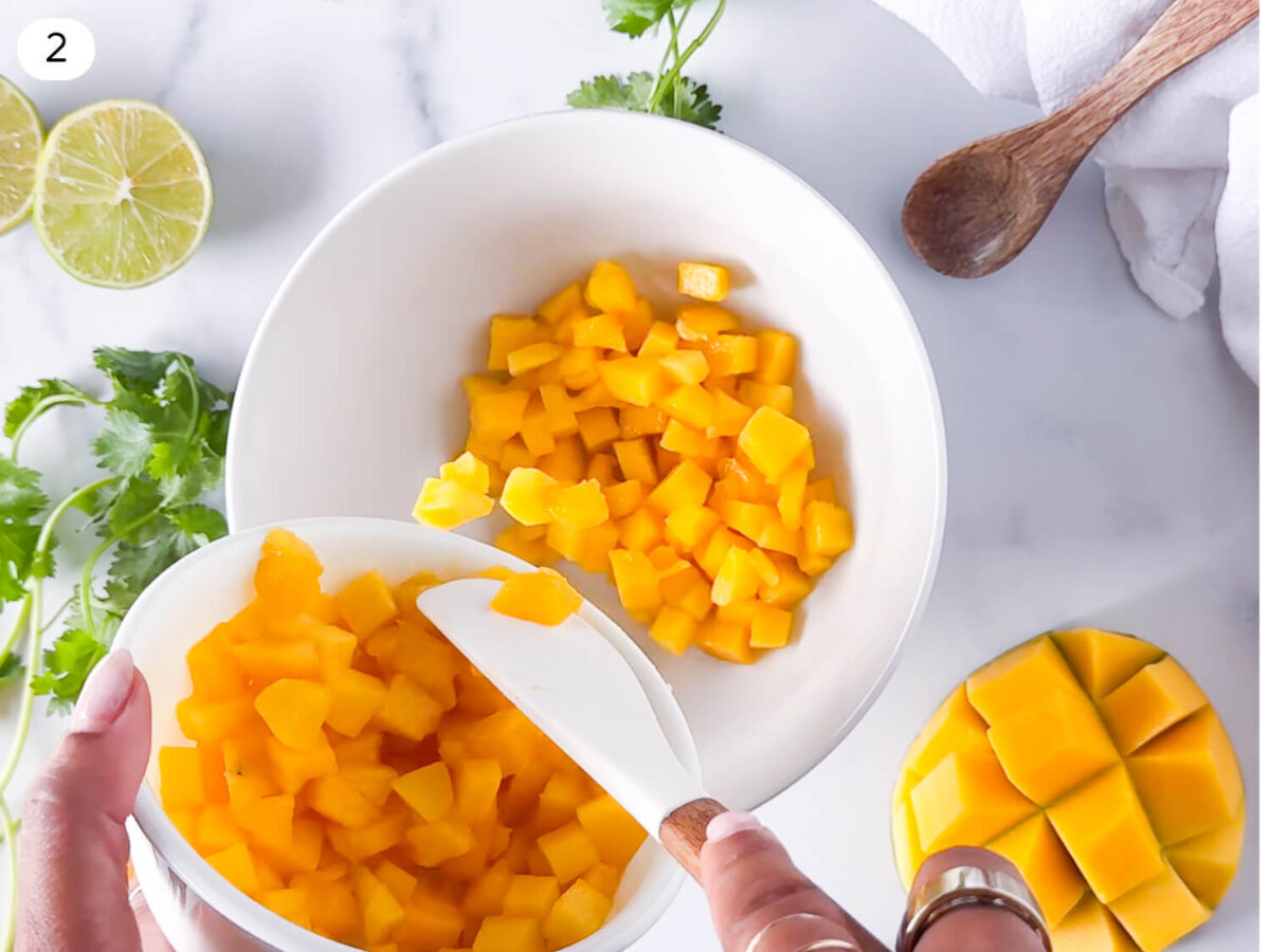 step 2 photo of sliced mangoes being added to a mixing bowl