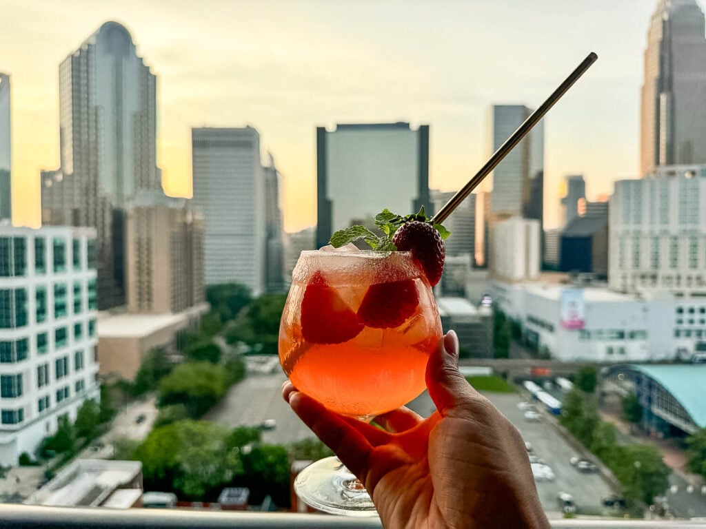 Strawberry Hennessy Margarita in front of a city skyline