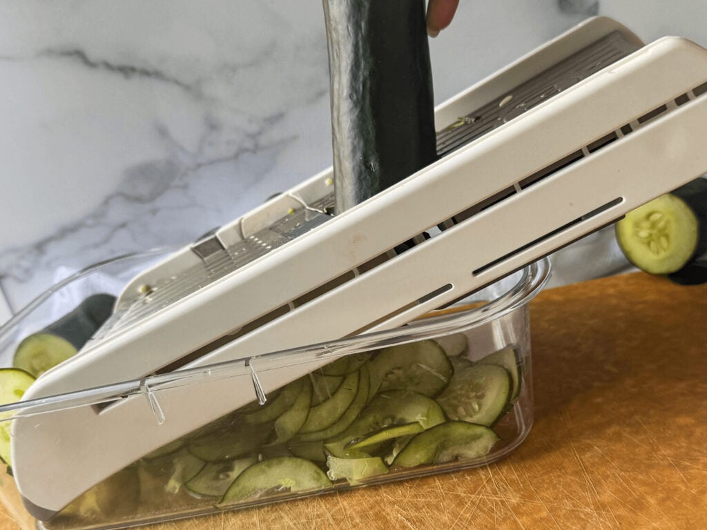 photo of mandoline slicing cucumbers