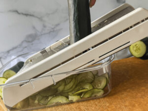 photo of mandoline slicing cucumbers