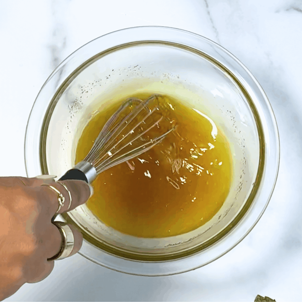 photo of whisking honey lime dressing ingredients together