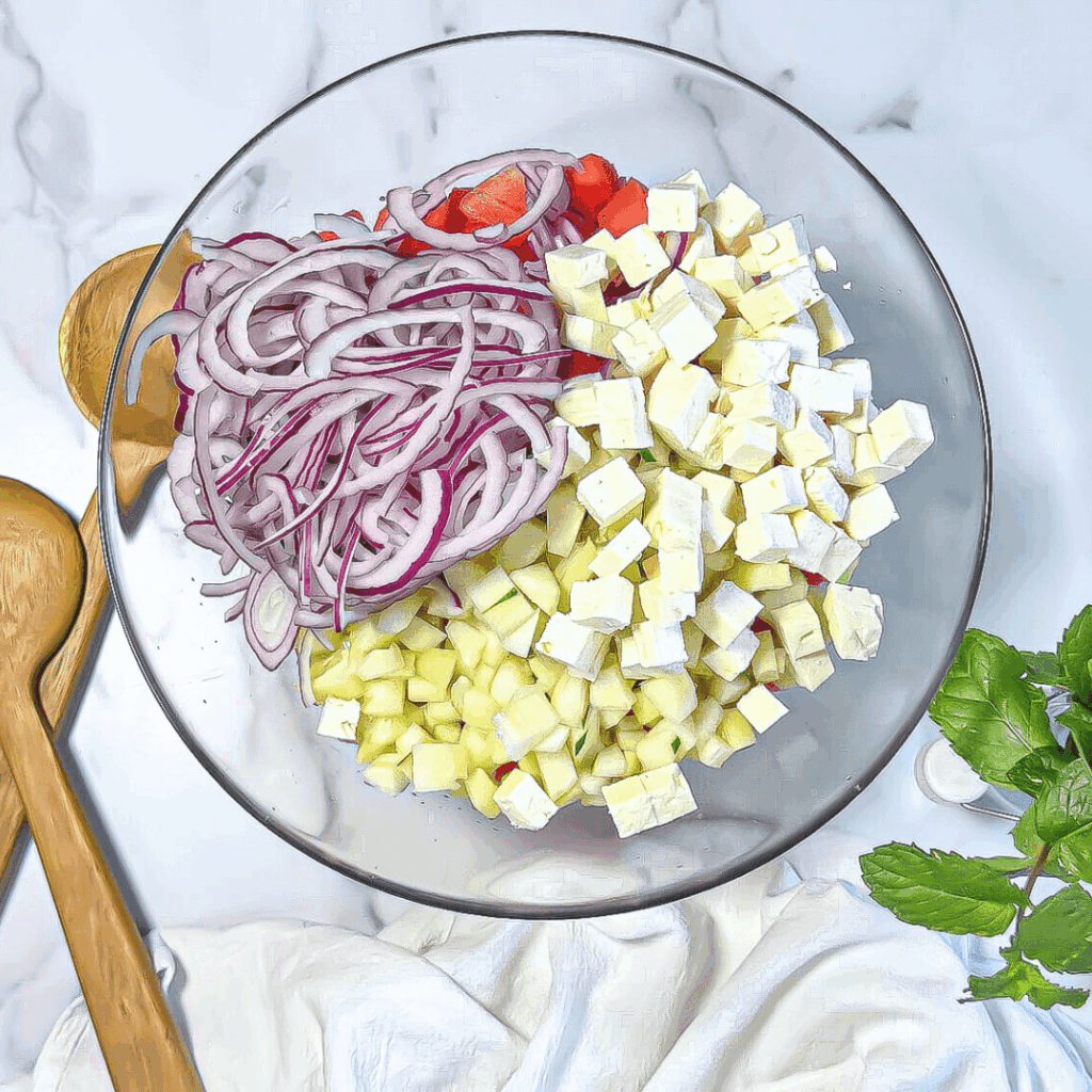 photo of watermelon salad ingredients in a glass bowl
