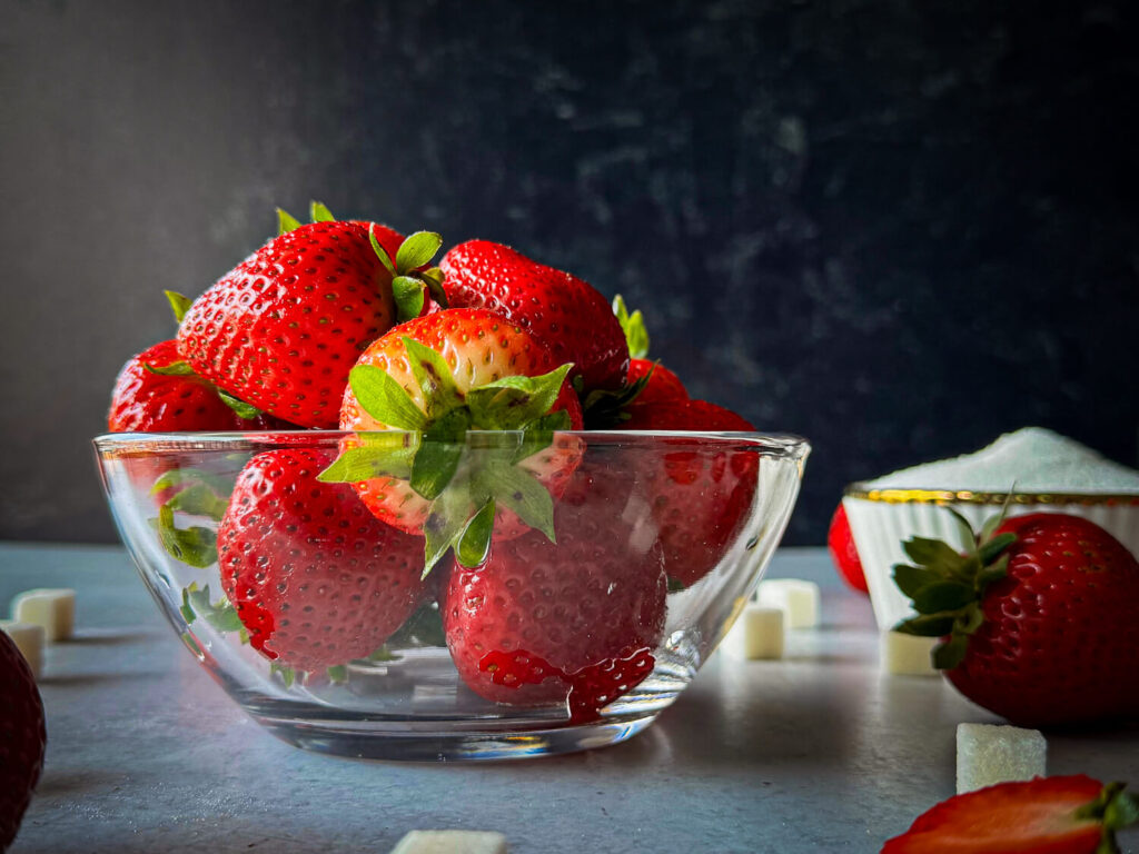 close up photo of strawberries in a glass bowl