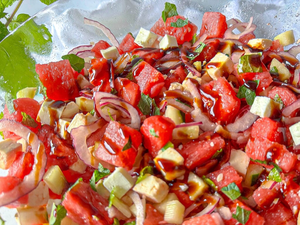 photo of watermelon feta and cucumbers in a glass bowl