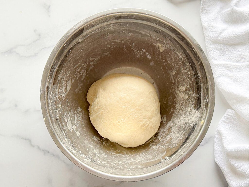 photo of tortilla dough resting in a metal bowl
