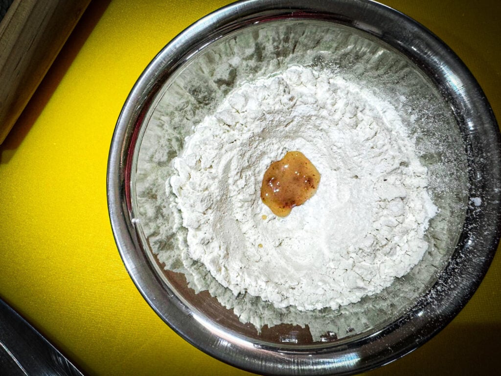 photo of lard inside well of flour