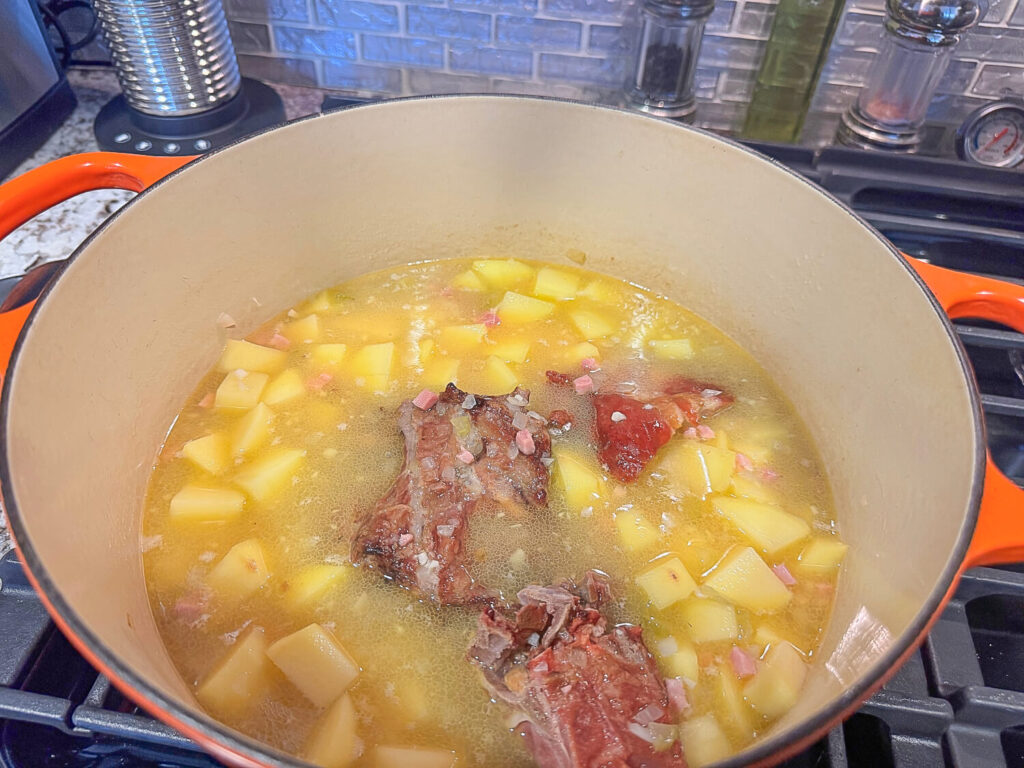 photo of potatoes and smoked meat in the pot