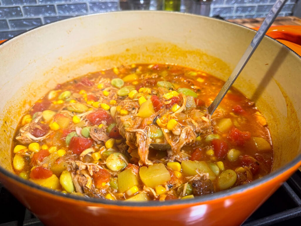 scooping Brunswick Stew out of the pot