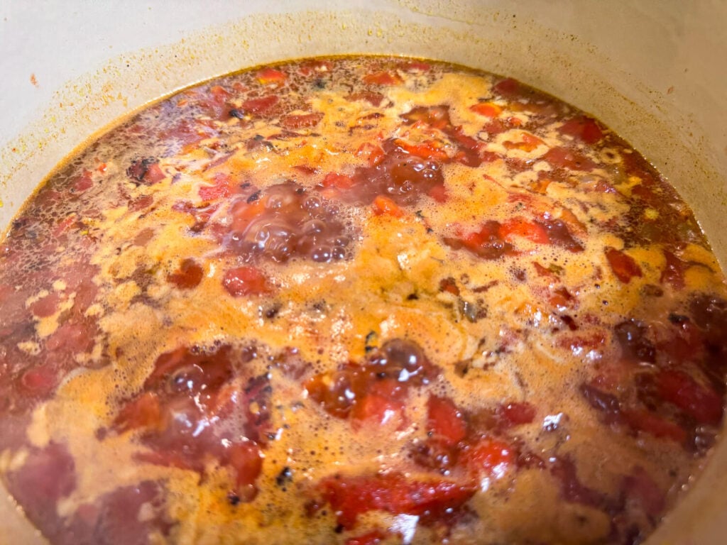 photo of fire roasted tomatoes and chicken broth simmering