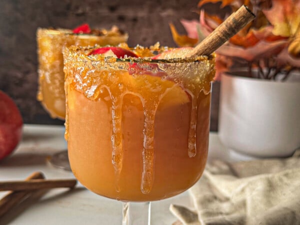 photo of apple cider sangria with a cinnamon stick garnish