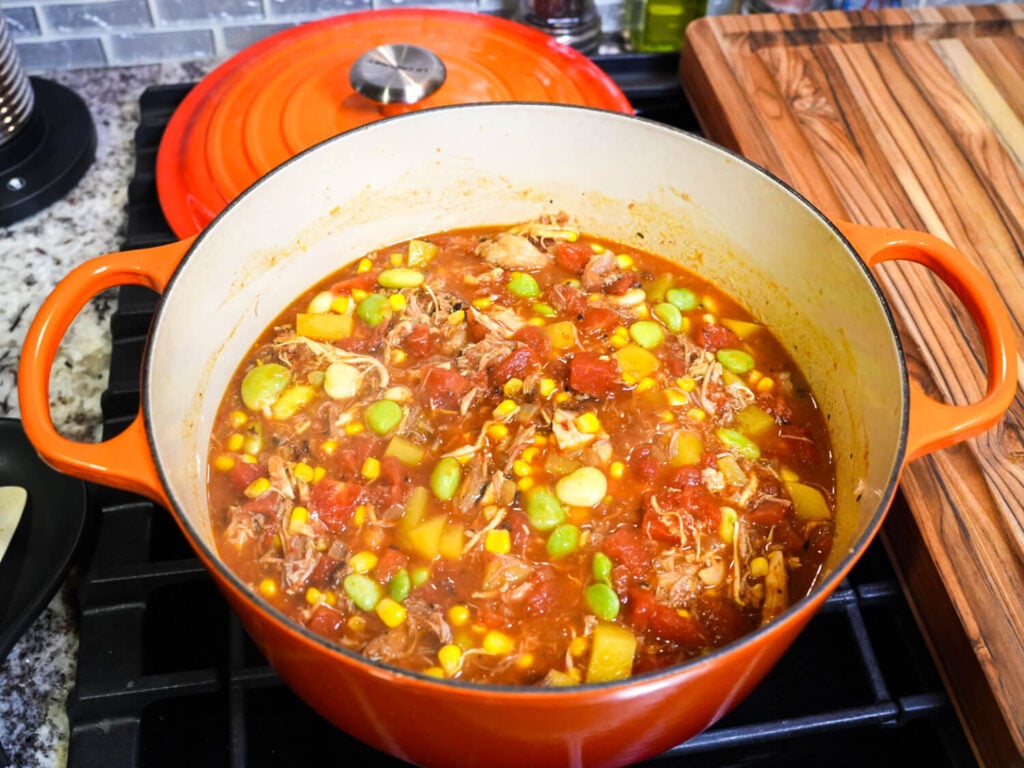 Overhead photo of Brunswick Stew in an orange dutch oven on the stove