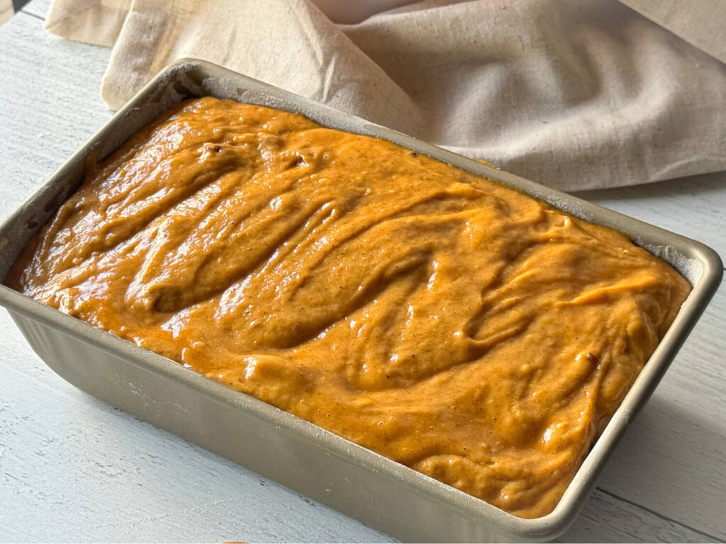 pumpkin bread combined ingredients in a bread pan