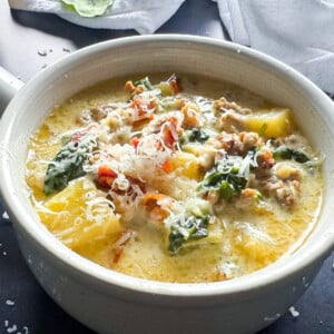 Zuppa Toscana Soup, the Olive Garden Copcat recipe in a soup bowl garnished with parmesan cheese and bacon