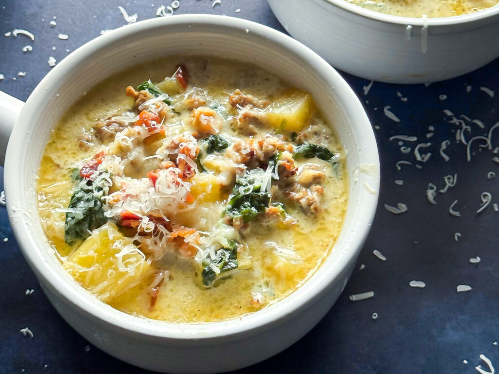 close up photo of Zuppa Toscana Soup. in a white bowl
