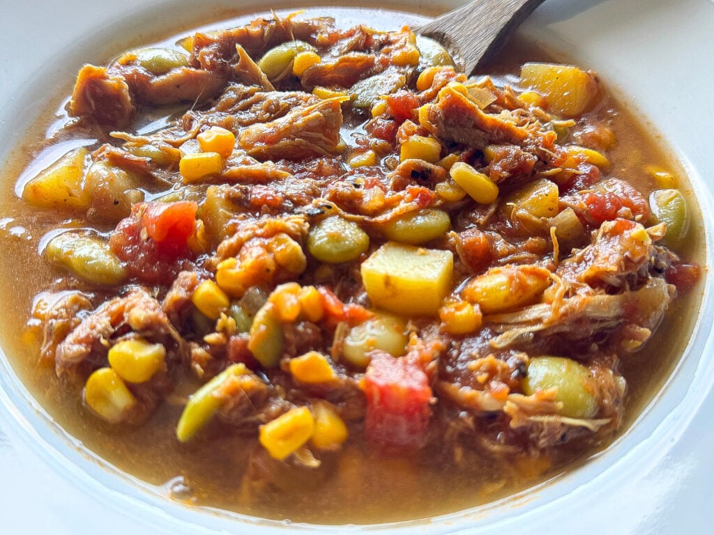close up photo of Brunswick Stew steaming in a white bowl