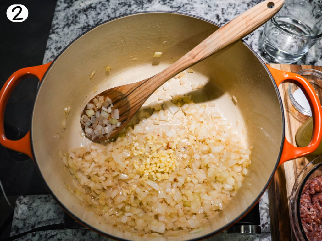 photo of onions and garlic being saut&eacute;ed in a dutch oven