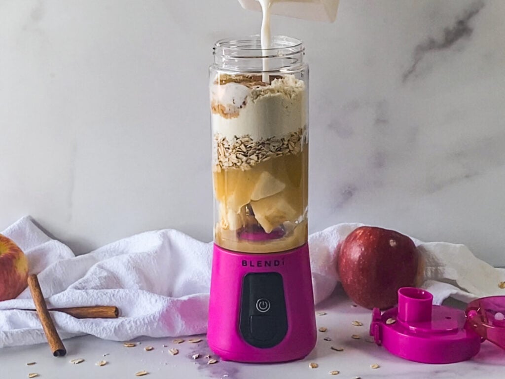 photo of almond milk being poured into the blender for an apple smoothie