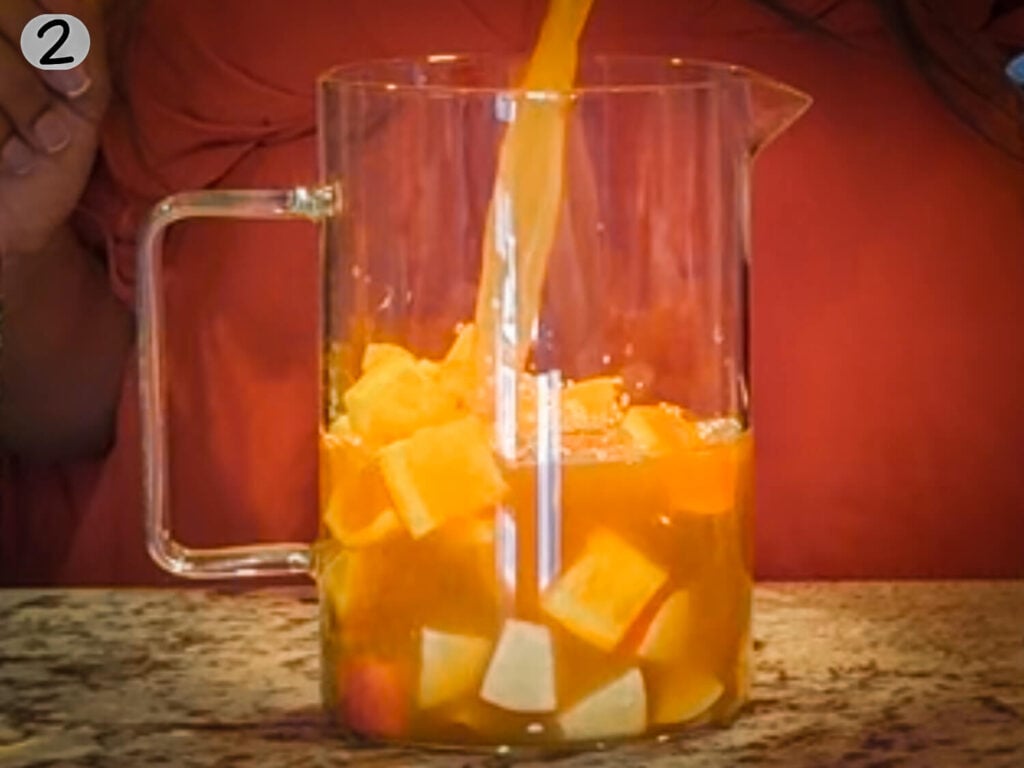 photo of pouring ingredients into a pitcher to make apple cider sangria