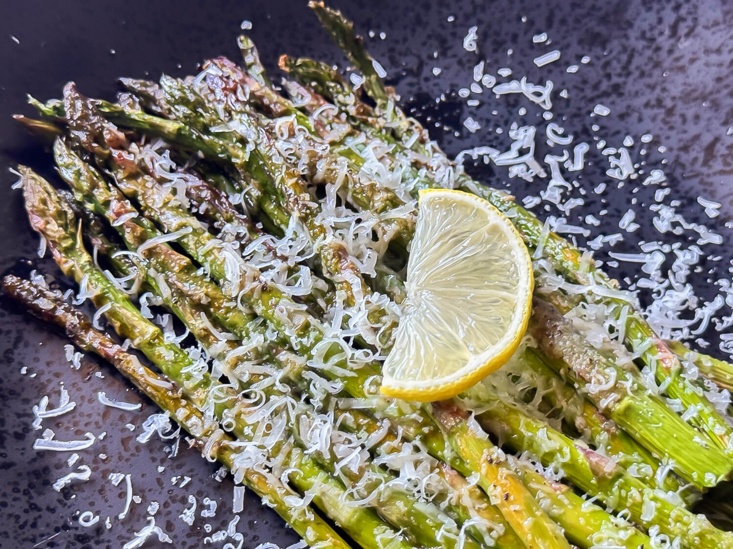 photo of Oven Roasted Asparagus on a black plate