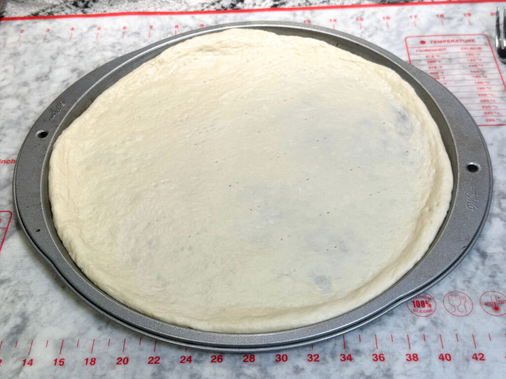 photo of pizza crust before going in the oven