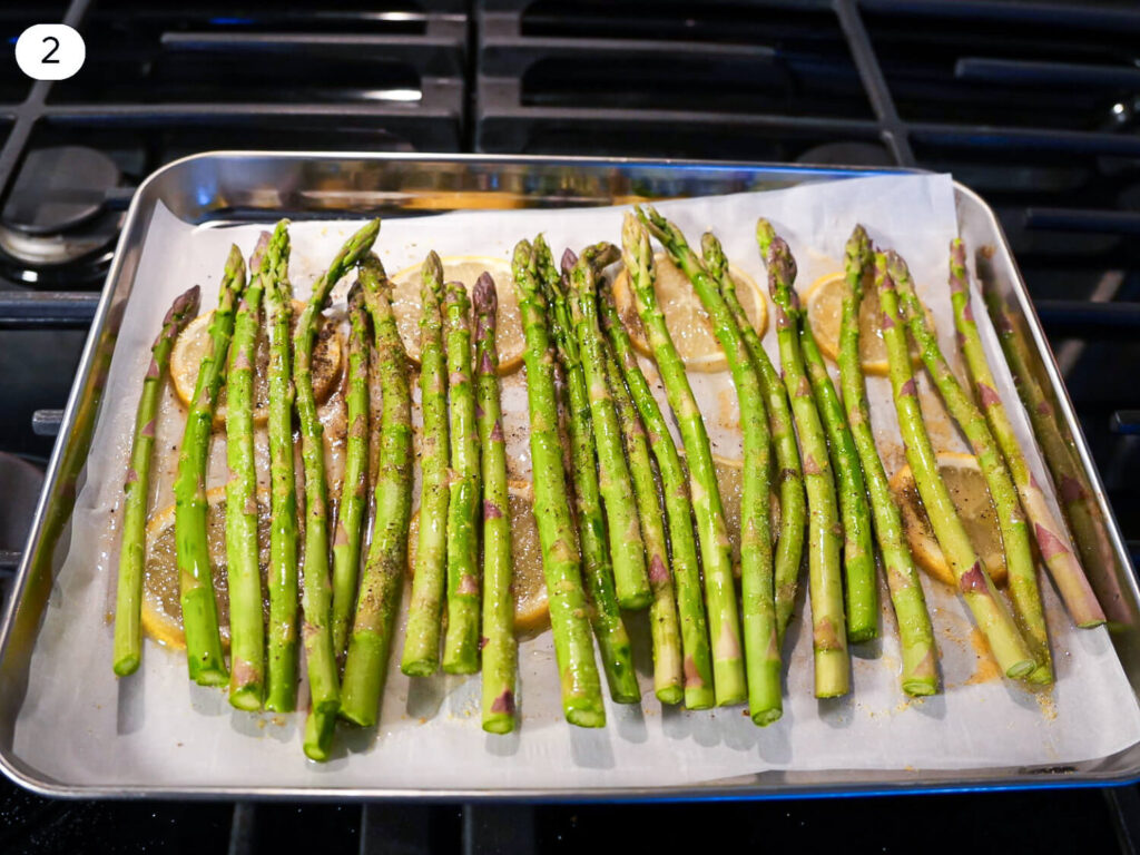 photo of Oven Roasted Asparagus on a baking dish garnished with parmesan cheese