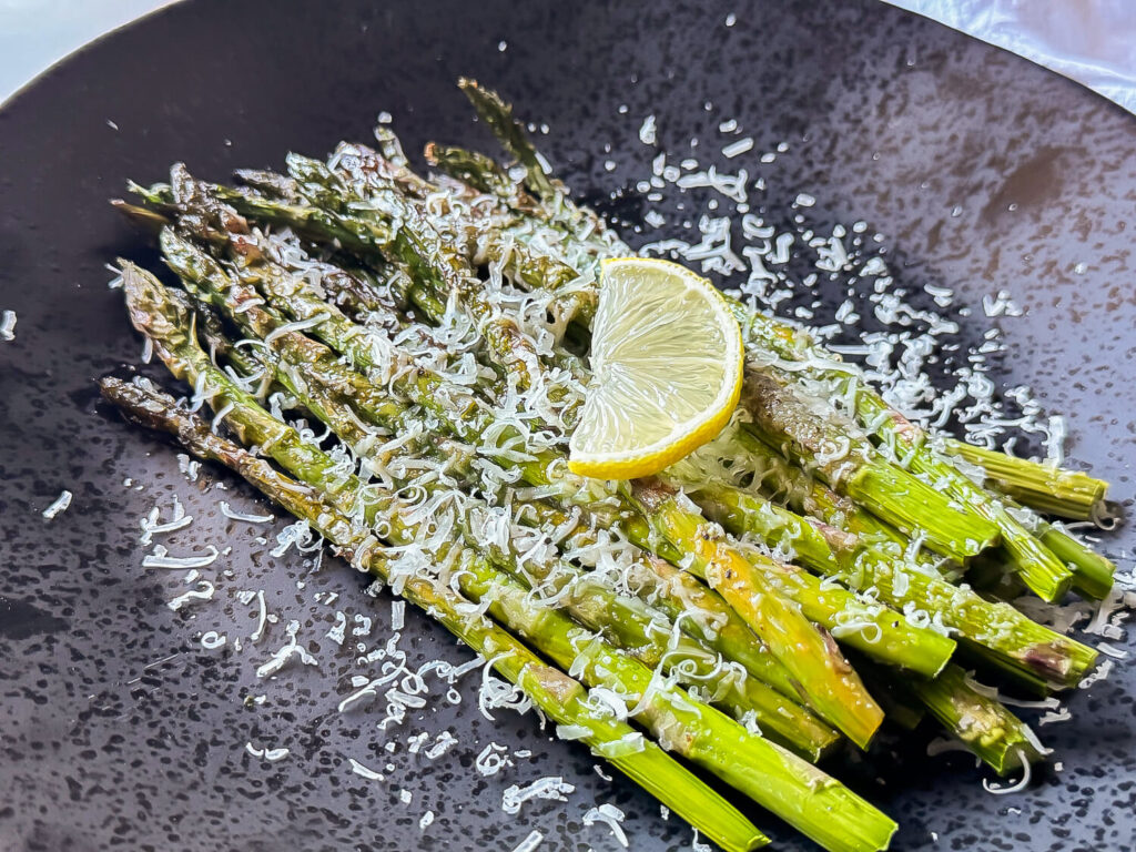 photo of Oven Roasted Asparagus on a black plate