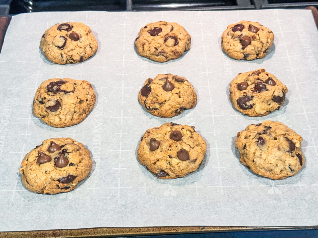 Oatmeal Chocolate Chip Cookies fresh out of the oven on a baking sheet