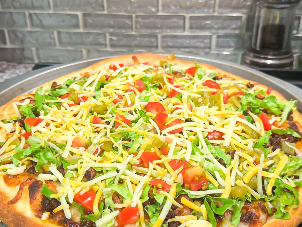 taco pizza with peppers and cheese on top