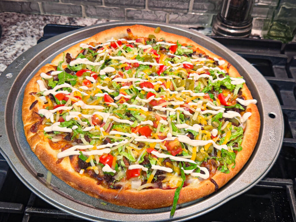 taco pizza with sour cream on top