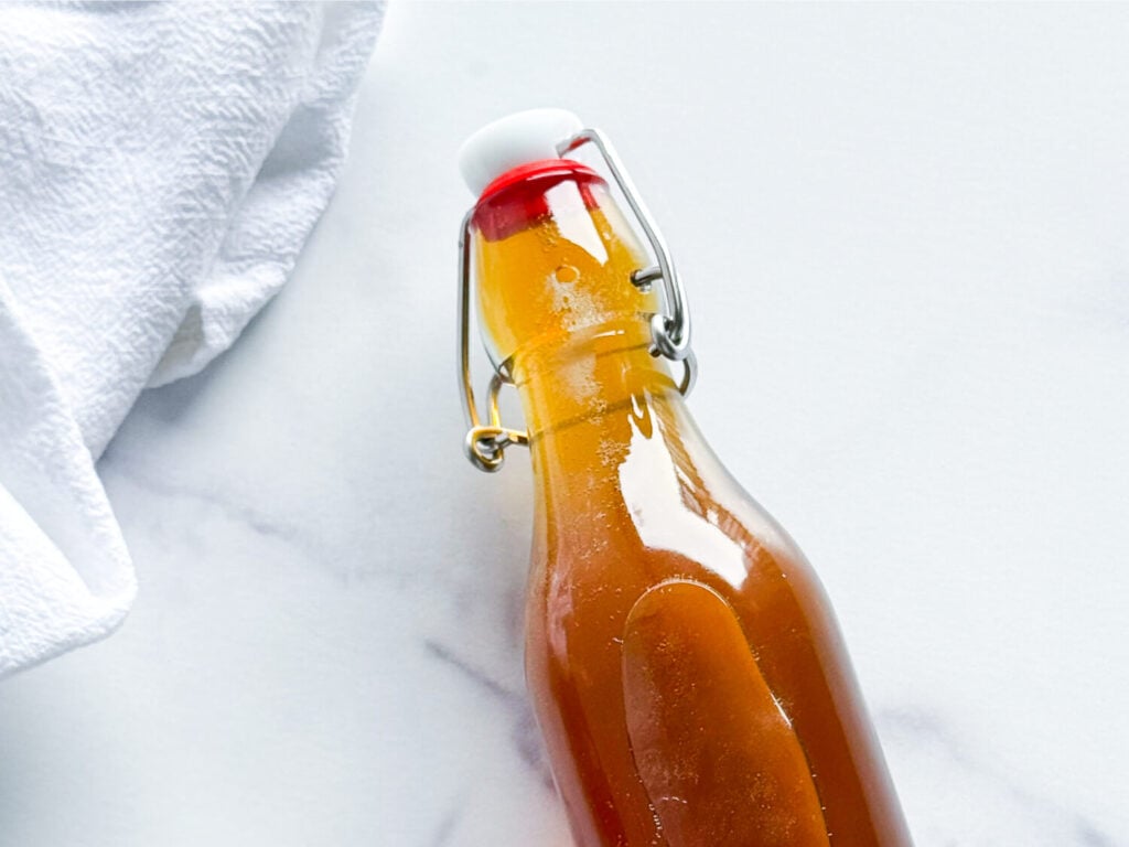 Overhead shot of honey syrup in an airtight container