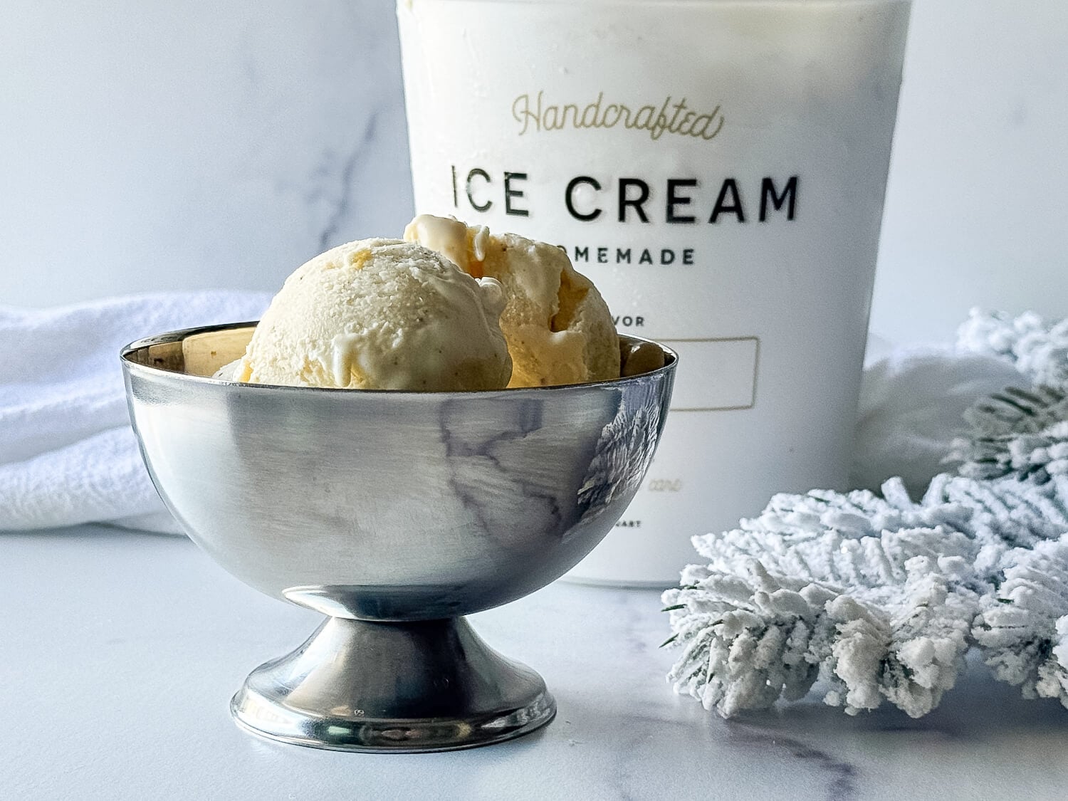 photo of Eggnog Ice Cream in a silver ice cream cup